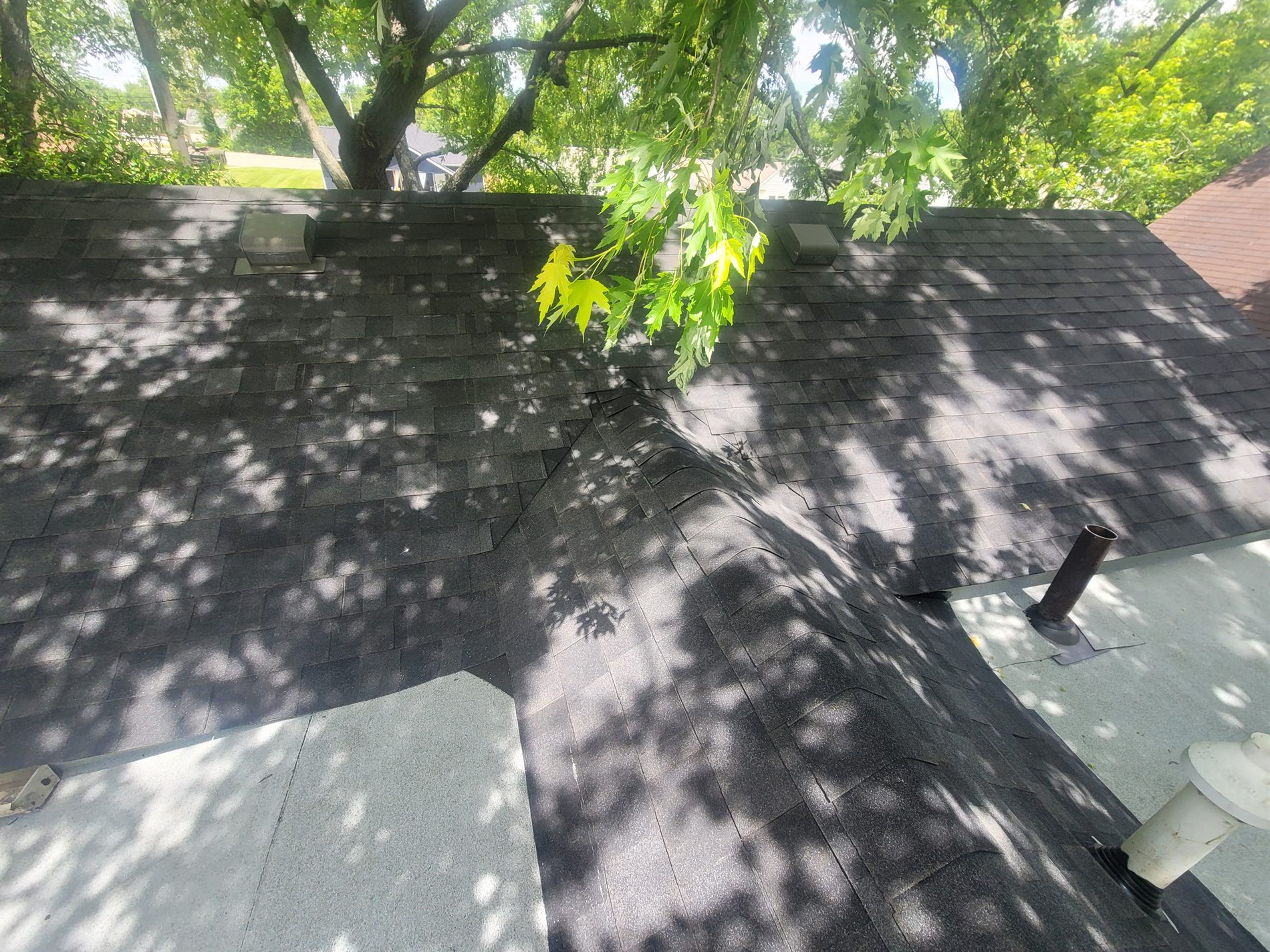 Finished dark shingle roof with vents