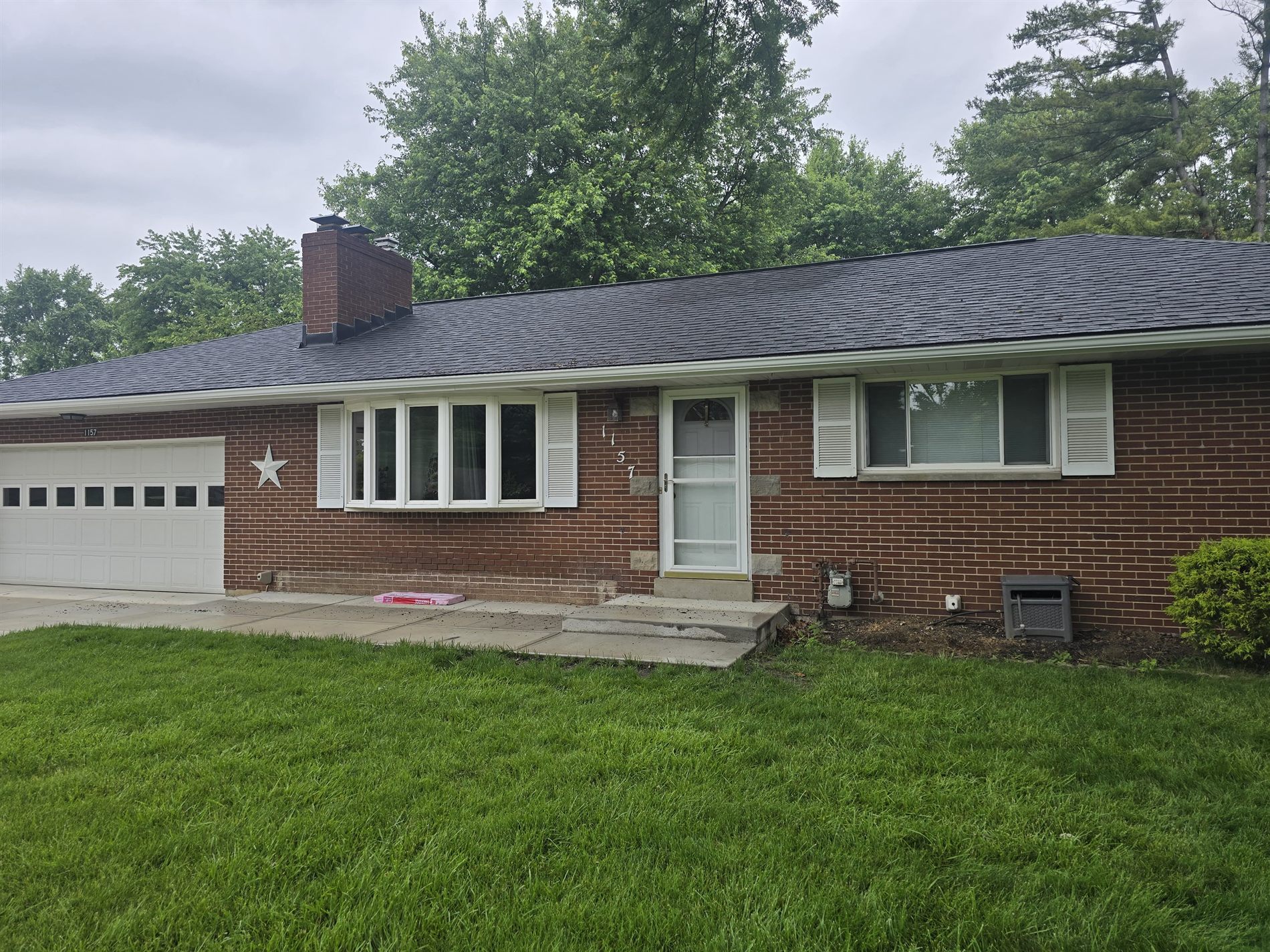 Completed brick home with new dark shingle roof